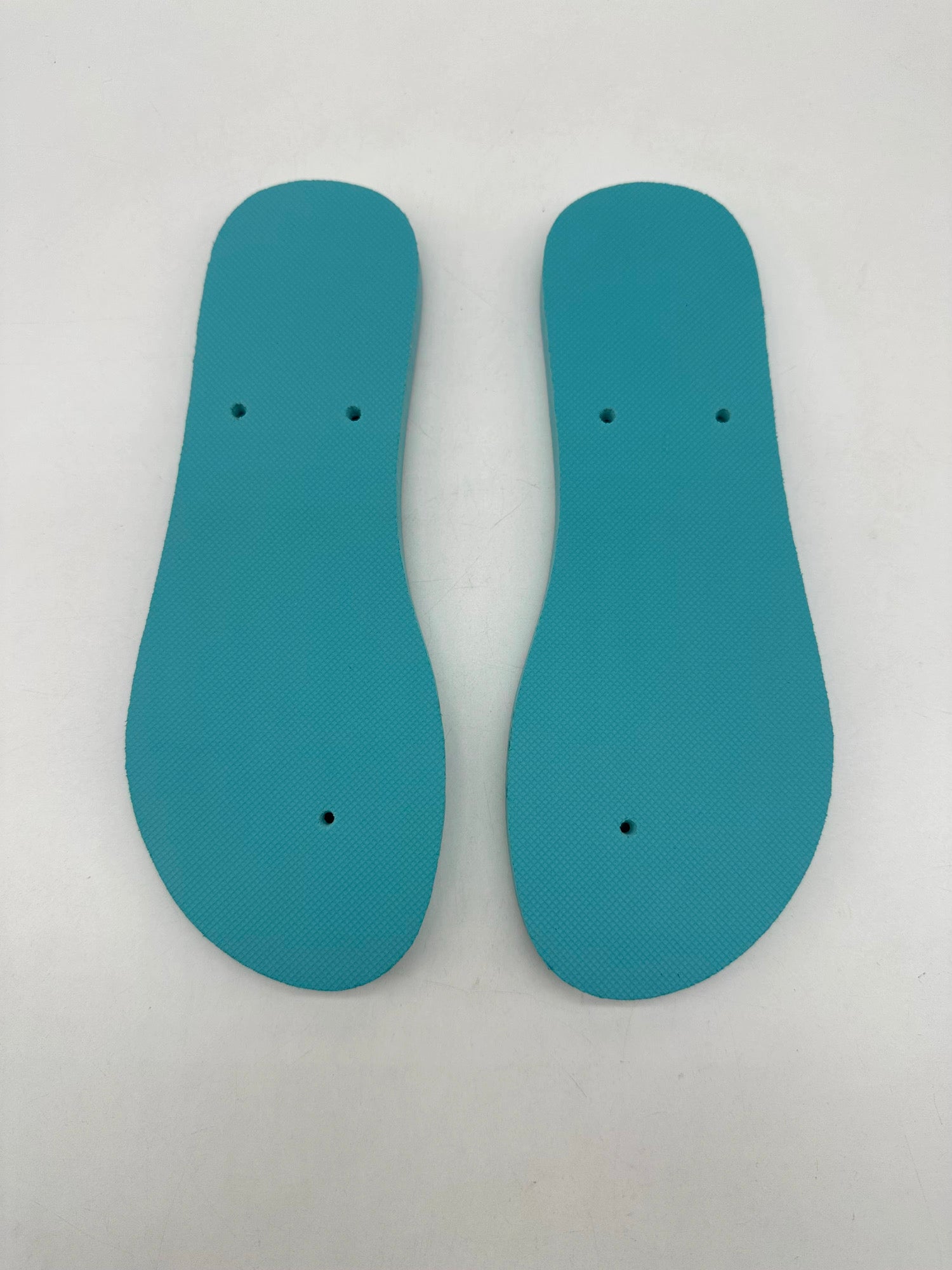 Actual FlipLab soles photographed from above, showing the silhouette and textured footbed